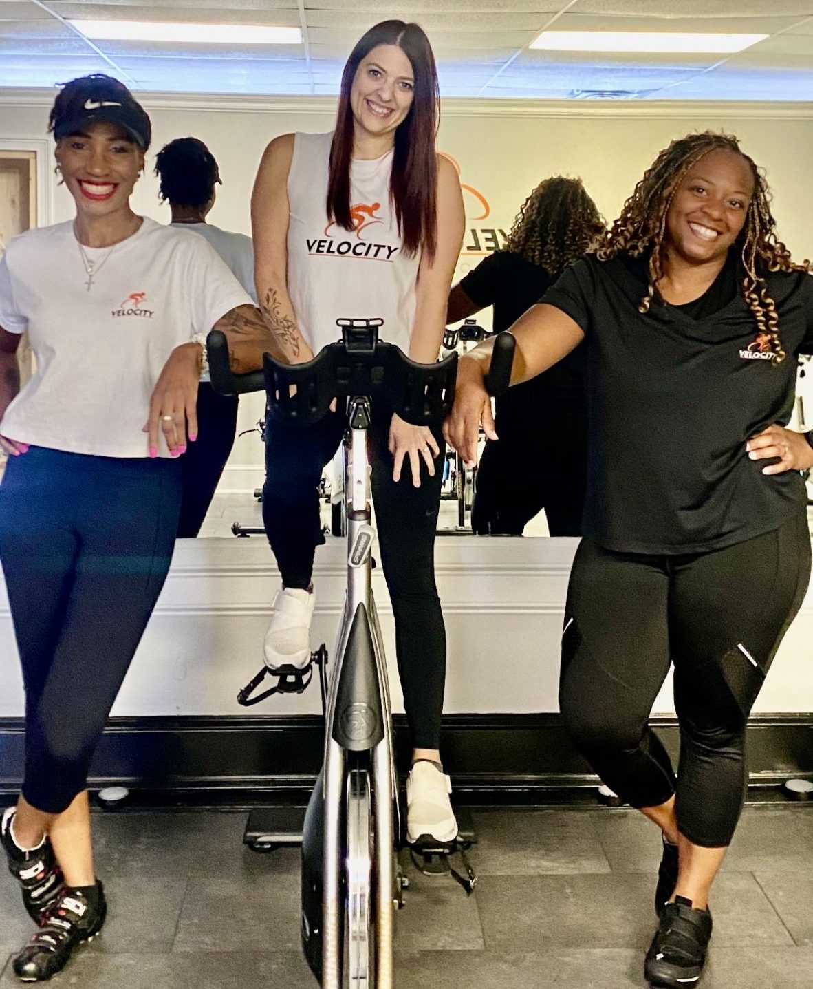 Screenshot Three employees sitting in front of exercise equipment